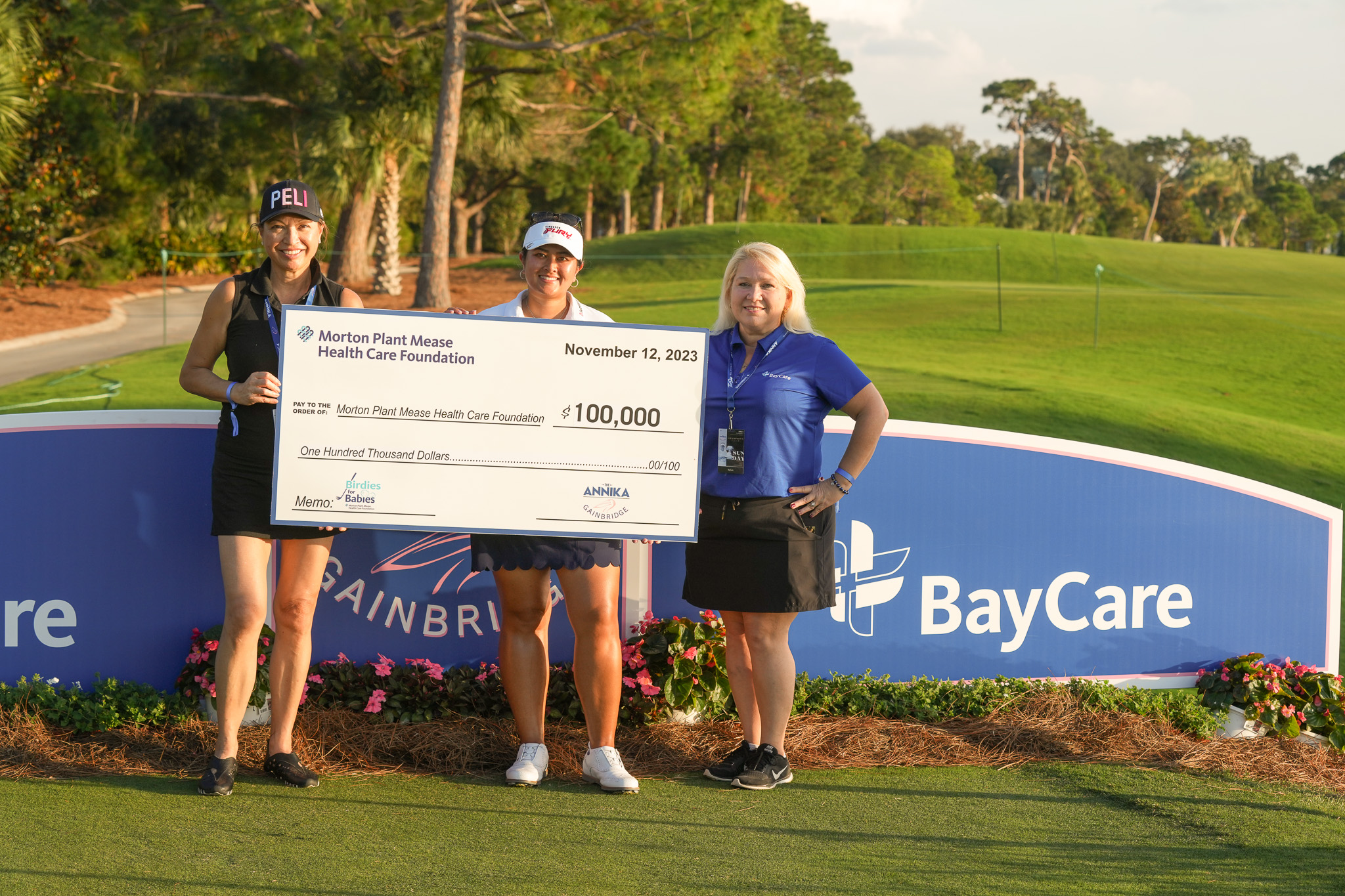 group posing with charitable check