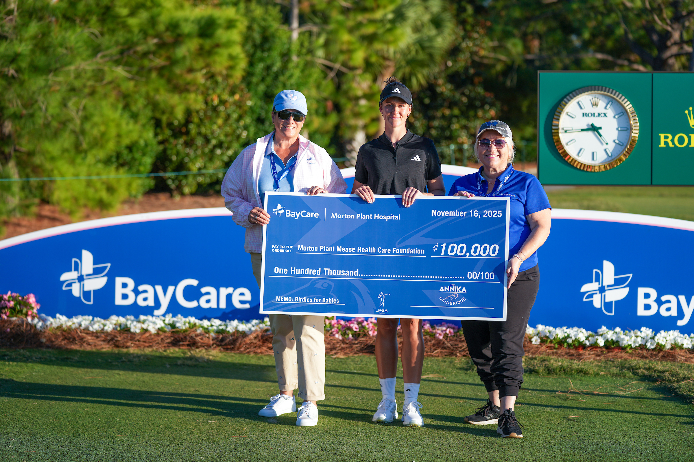 group posing with charitable check