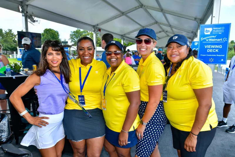 group of women taking a photo wearing yellow shirts