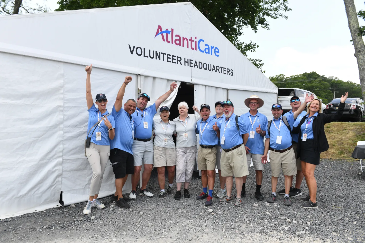 group of volunteers in front of sponsor tent